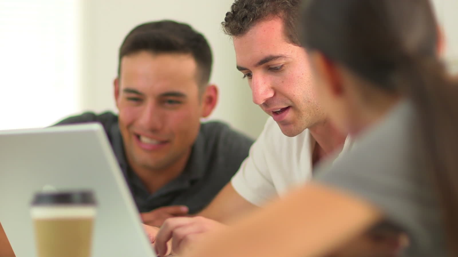 Frame from the Arvato film: real filmed footage of hands typing on a laptop