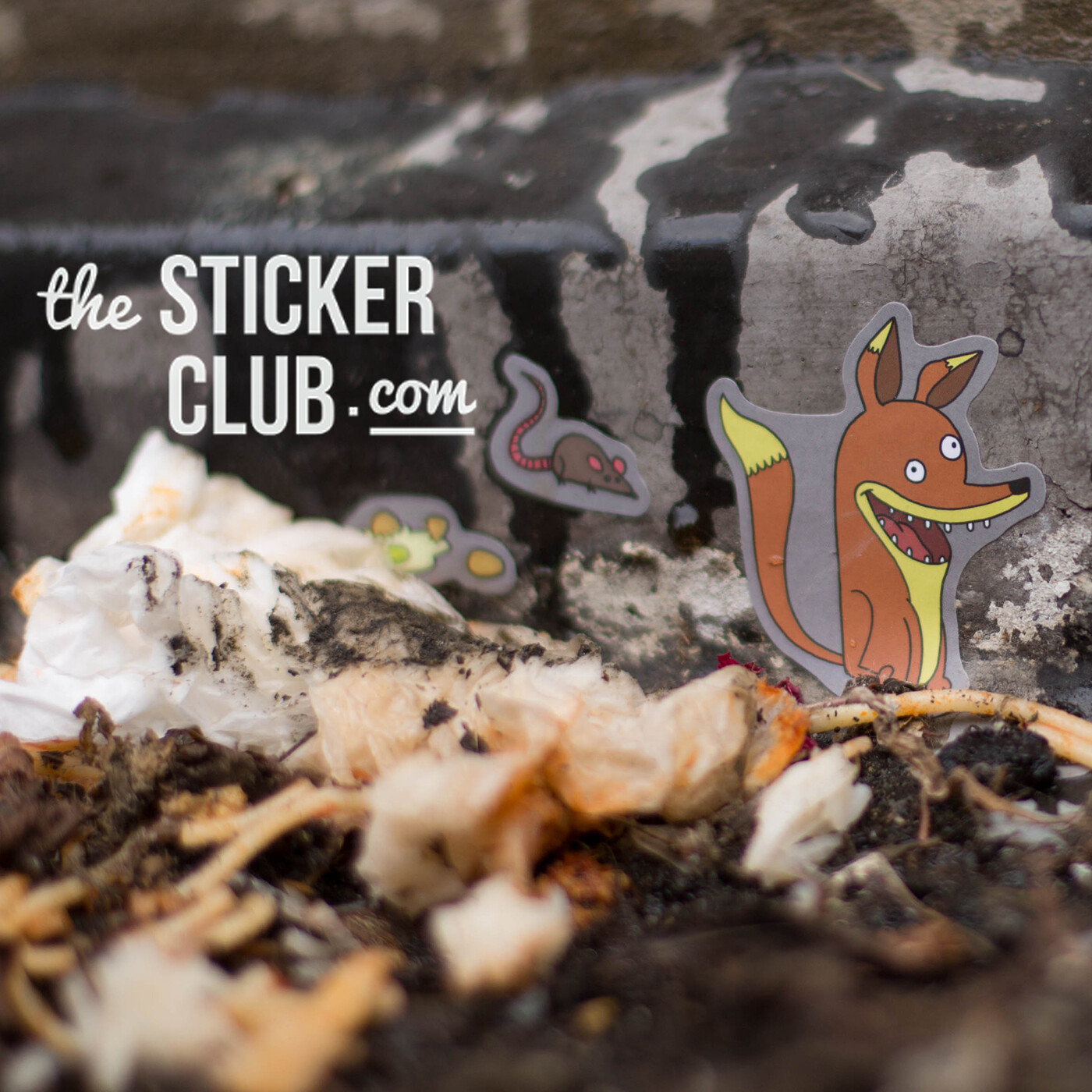 The Sticker Club fox and rat stickers among food waste, with the thestickerclub.com wordmark